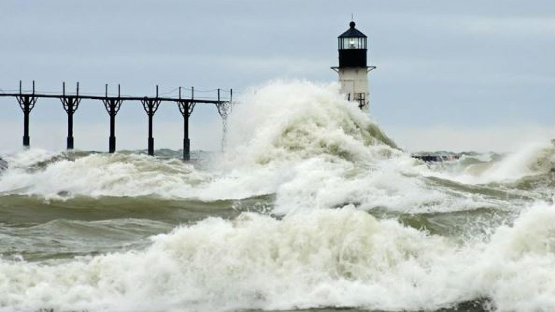 waves crashing against lighthouse in St. Joseph, Michigan