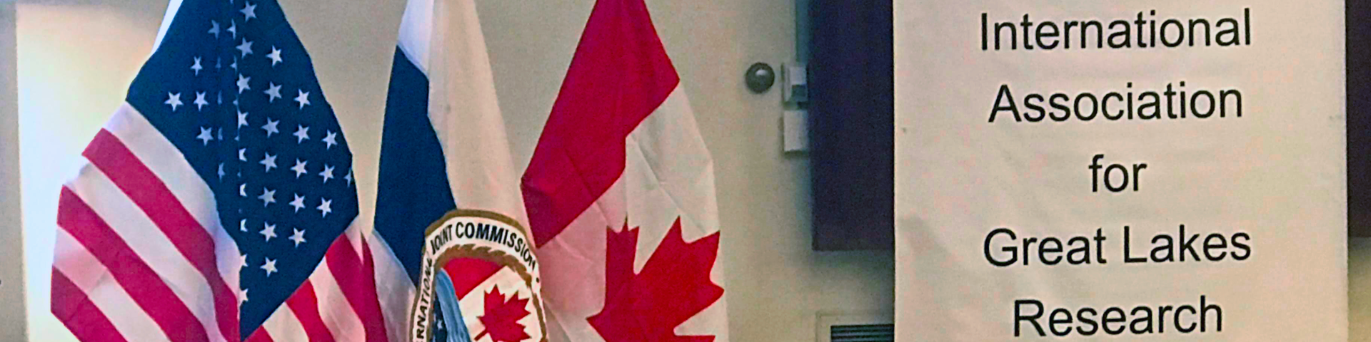 Image of US, Canadian and IJC flag at IAGLR conference in 2019